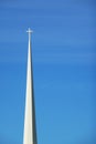 White church spire against a blue sky