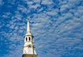 White church steeple set against a blue sky. Royalty Free Stock Photo