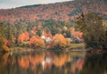 A white church steeple stands out among brilliant fall foliage