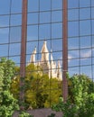 White church towers mirrored on the facade of a modern glass building Royalty Free Stock Photo