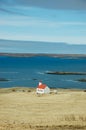 White church, turquoise sea, hayfield, Iceland