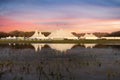 White circus tent with sunset red sky