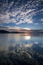 White Cirrus Cloud in a Blue sky with Water Reflections Royalty Free Stock Photo