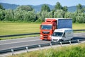 White CitroÃÂ«n van overtakes red MAN truck on slovak D1 highway in countryside. Royalty Free Stock Photo