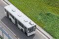 White city bus traveling on the highway, top view. Royalty Free Stock Photo