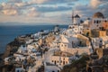 White city on a slope of a hill at sunset, Oia, Santorini, Greece Royalty Free Stock Photo