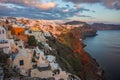 White city on a slope of a hill at sunset, Oia, Santorini, Greece Royalty Free Stock Photo