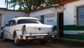 A white classic car parked front of house Royalty Free Stock Photo