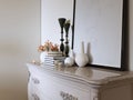 White classic chest of drawers with decor and picture