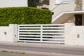 White classical home door aluminum gate sliding slats portal garden entry suburb house Royalty Free Stock Photo