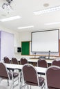 White classrooms are currently available with student desks and chairs Royalty Free Stock Photo