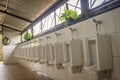 White clean ceramic urinal bowls in the public men's toilet. Row Royalty Free Stock Photo