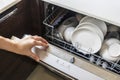 White clean dish or bowl and cup inside the washer device.Selective focus with blur background. Royalty Free Stock Photo