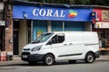 White clean Ford Transit Custom van in front of one of many branches of Coral gambling and betting offices at a street in Glasgow