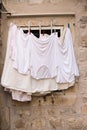 White clean laundry hangs on building Royalty Free Stock Photo