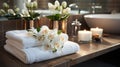 White, clean, neatly folded towels lie on a wooden table . The theme of staying at the hotel is relaxation and comfort