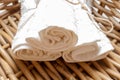 White clean rolled terry towel stack on wicker basket background. Close up Royalty Free Stock Photo