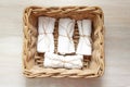 White clean rolled terry towel stack in wicker basket on natural wooden background. Flat Lay Royalty Free Stock Photo