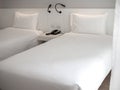 White clean twin bed with white pillows in hotel bedroom Royalty Free Stock Photo