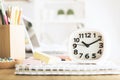 White clock on office desktop Royalty Free Stock Photo