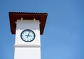 White clock tower on a background of blue sky. Time to rest Royalty Free Stock Photo