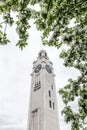 White clock tower seen through blooming trees Royalty Free Stock Photo