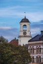 white clock tower in Vyborg city, Russia at sunset in autumn Royalty Free Stock Photo