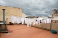 White clothes drying on the rope on the rooftop, laundry hanging on terrace Royalty Free Stock Photo