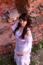 White clothes on a young girl on brick wall background Royalty Free Stock Photo