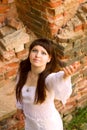 White clothes on a young girl on brick wall background Royalty Free Stock Photo