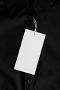 White clothing tag mockup on a black shirt