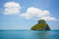 white cloud above the limestone island on the ocean in sunny day