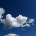 White cloud against a blue sky, illuminated by sunlight from one side