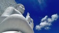 White cloud and big white Buddha sculpture under blue sky