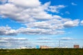 White cloud in blue sky over city and green forest Royalty Free Stock Photo