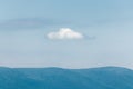 White cloud in the blue sky over the mountains Royalty Free Stock Photo