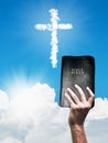 White cloud Christian cross and hand with Bible Royalty Free Stock Photo