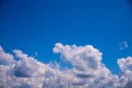 White cloud and clear blue sky above. Sunny cloudscape photo background. Skyscape with fluffy clouds Royalty Free Stock Photo