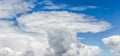 A white cloud of unusual shape on the background of a blue sky o Royalty Free Stock Photo