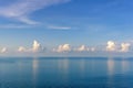 White clouds above tranquil ocean water