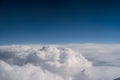 White clouds against a dark blue sky. View from the airplane window Royalty Free Stock Photo