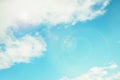 White clouds on the blue aquamarine color sky background. Sky with sun glare Royalty Free Stock Photo