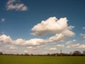 White Clouds in Blue skies Over Green Fields