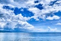 White clouds blue sky above blue sea