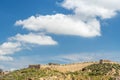 White clouds in the blue sky above the fortress in Cartagena, Spain