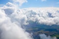 White clouds on blue sky background above green land, cumulus clouds high in skies, beautiful cloudy landscape view from plane, ea Royalty Free Stock Photo