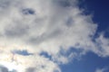 White clouds on a blue sky. Background for text and design. The sun behind the clouds, shines through Royalty Free Stock Photo