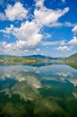 White clouds blue sky beautiful lake with wonderful mirror reflecion Royalty Free Stock Photo