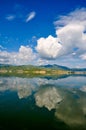 White clouds blue sky beautiful lake with wonderful mirror reflecion Royalty Free Stock Photo