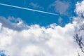 White Clouds Blue Sky Fluffy Sun Flare Airplane Trail Sunny Day Royalty Free Stock Photo